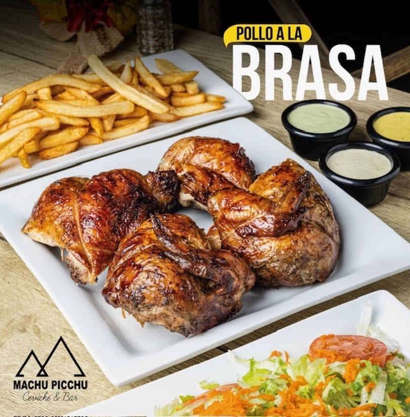 Machu Picchu's Pollo a la Brasa, a Peruvian roasted chicken dish with fries, salad, and sauces.